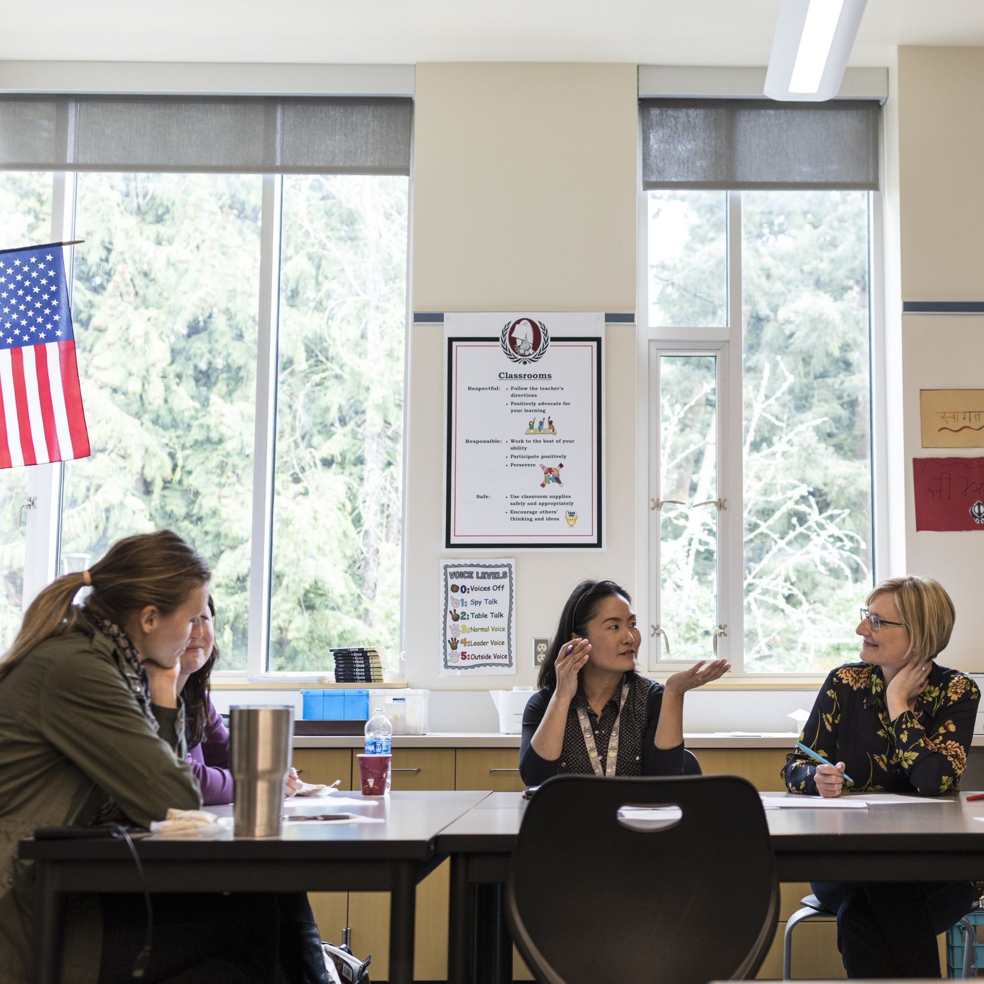 Teachers meet in a classroom